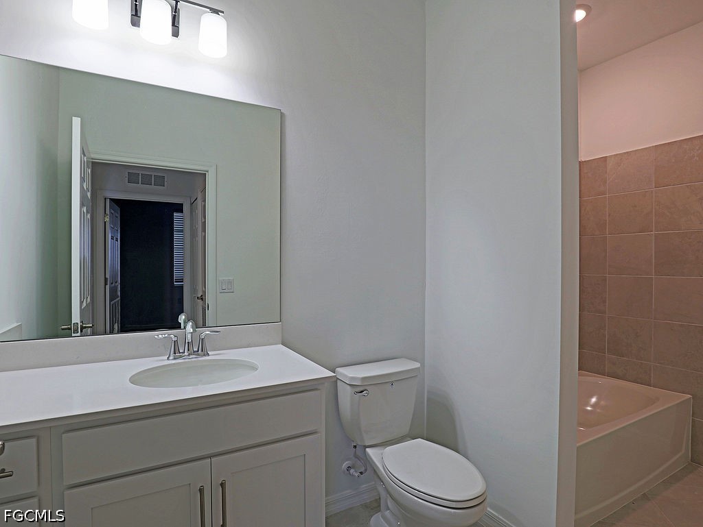 43997 Boardwalk Loop, Unit 1843 Punta Gorda, FL 33982 - Photo 8 of 11 a bathroom with a sink toilet and vanity