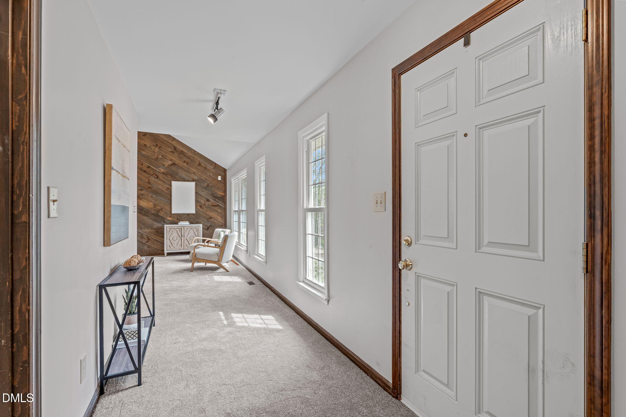 3304 Wade Avenue Raleigh, NC 27607 - Photo 3 of 38 a view of a hallway with a furniture and floor to ceiling window