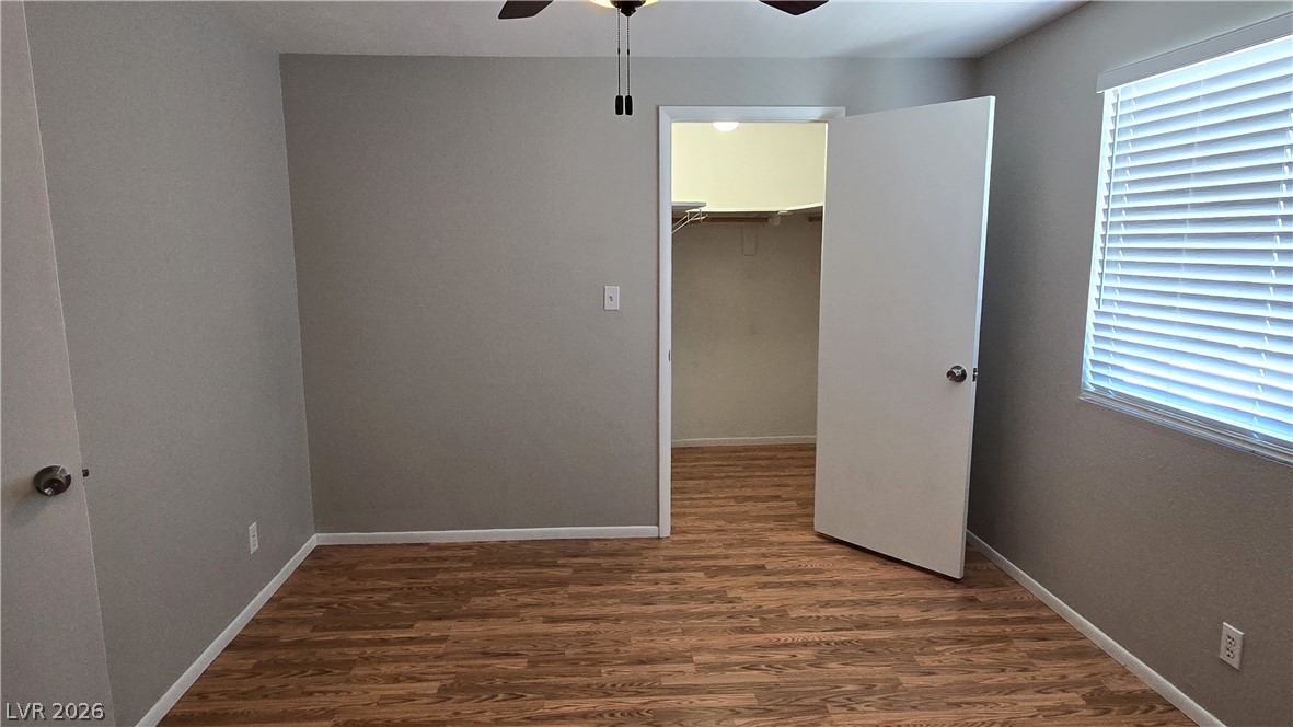 3849 Reflection Way Las Vegas, NV 89147 - Photo 14 of 25 This naturally illuminated bedroom offers durable hardwood flooring and a convenient walk-in closet.
