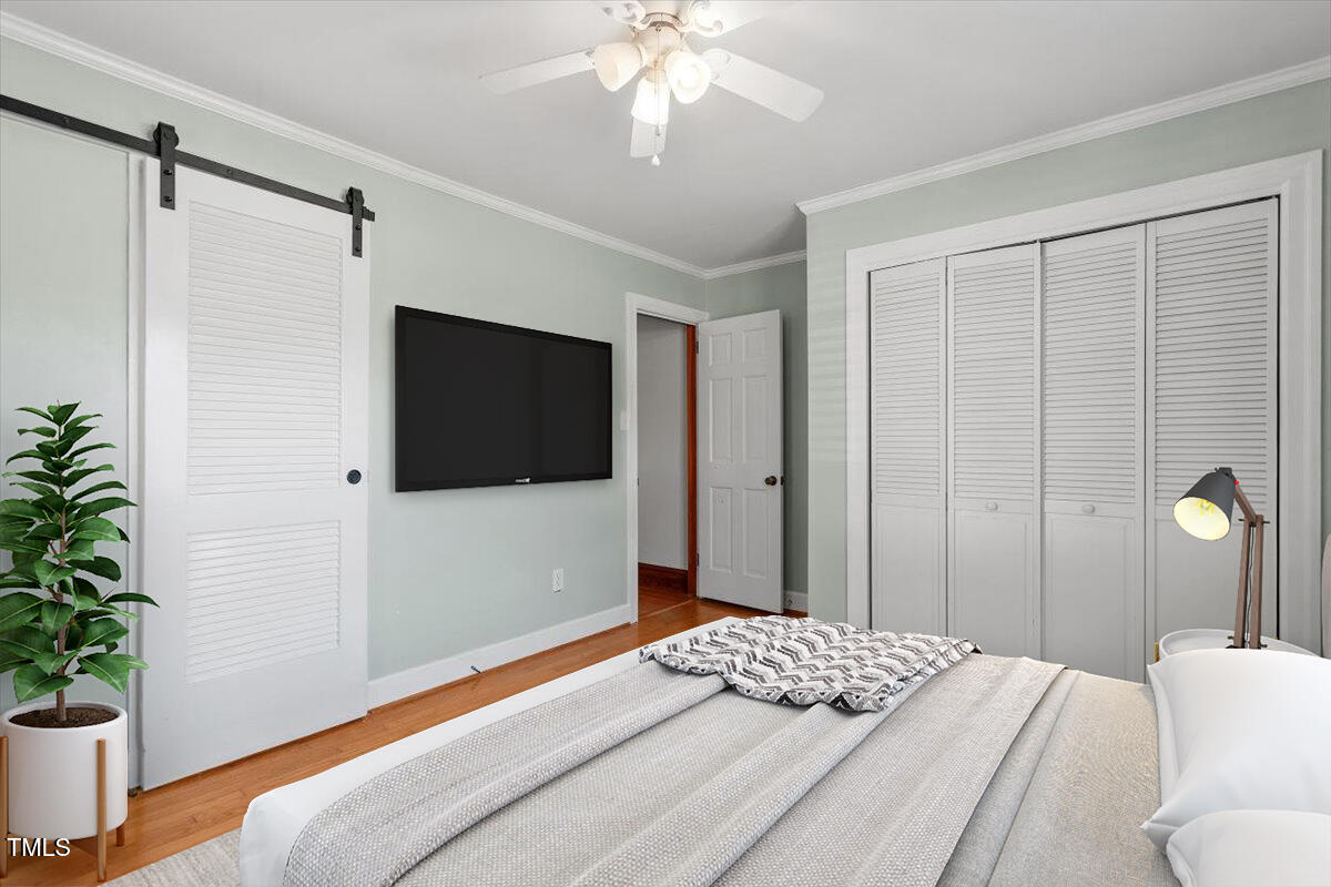 5707 Old Stage Road Raleigh, NC 27603 - Photo 14 of 50 a bedroom with a bed and a flat screen tv