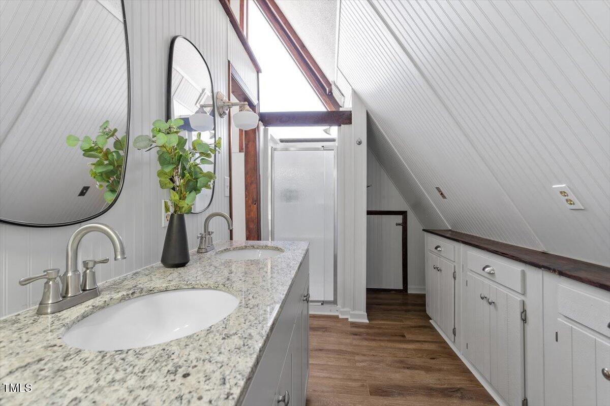 5707 Old Stage Road Raleigh, NC 27603 - Photo 21 of 50 a bathroom with a granite countertop sink a mirror and vanity