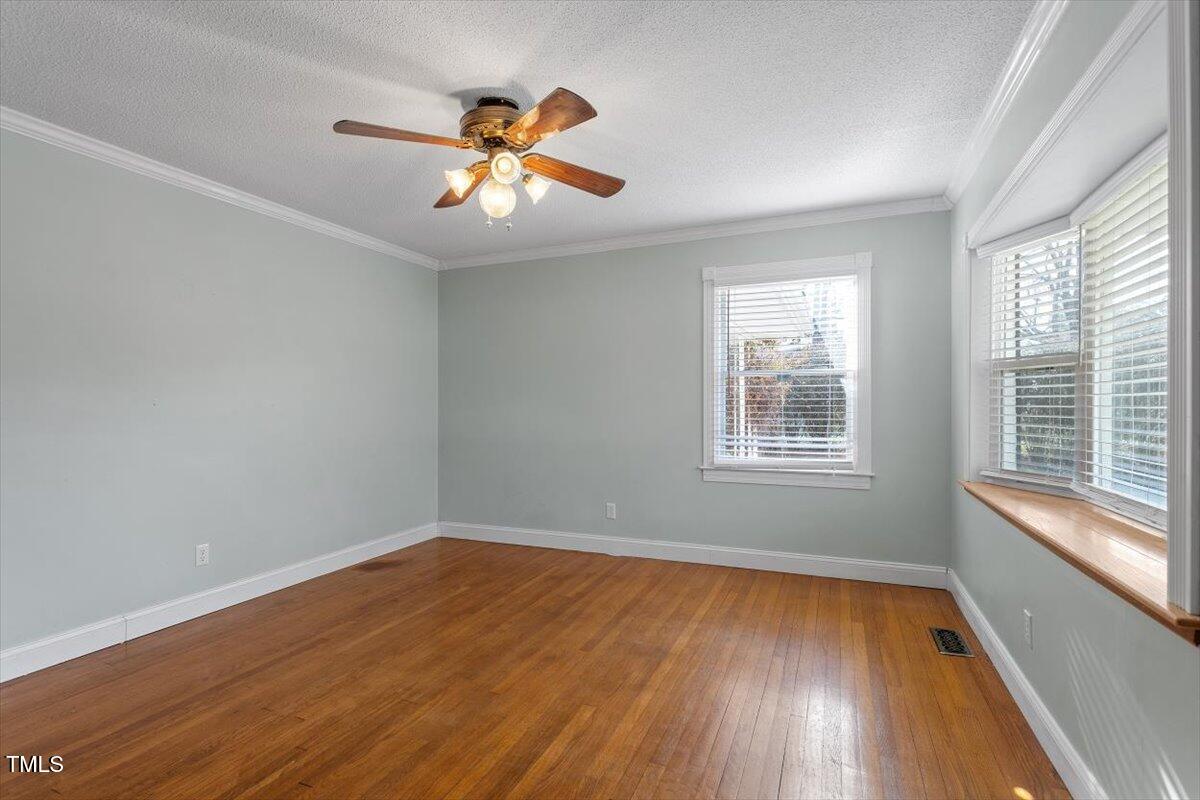 5707 Old Stage Road Raleigh, NC 27603 - Photo 22 of 50 a view of an empty room with wooden floor and a window