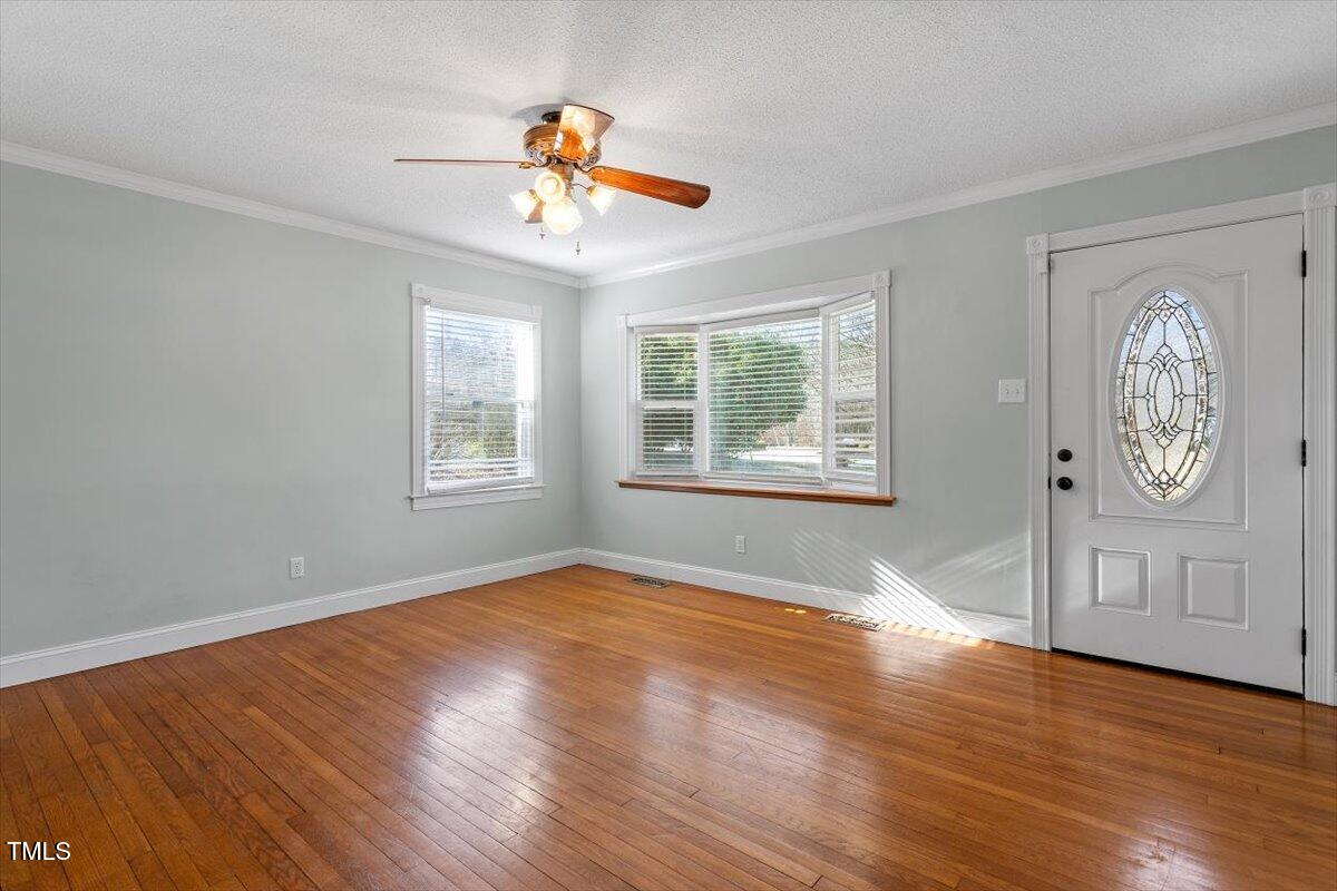 5707 Old Stage Road Raleigh, NC 27603 - Photo 23 of 50 a view of an empty room with window and wooden floor