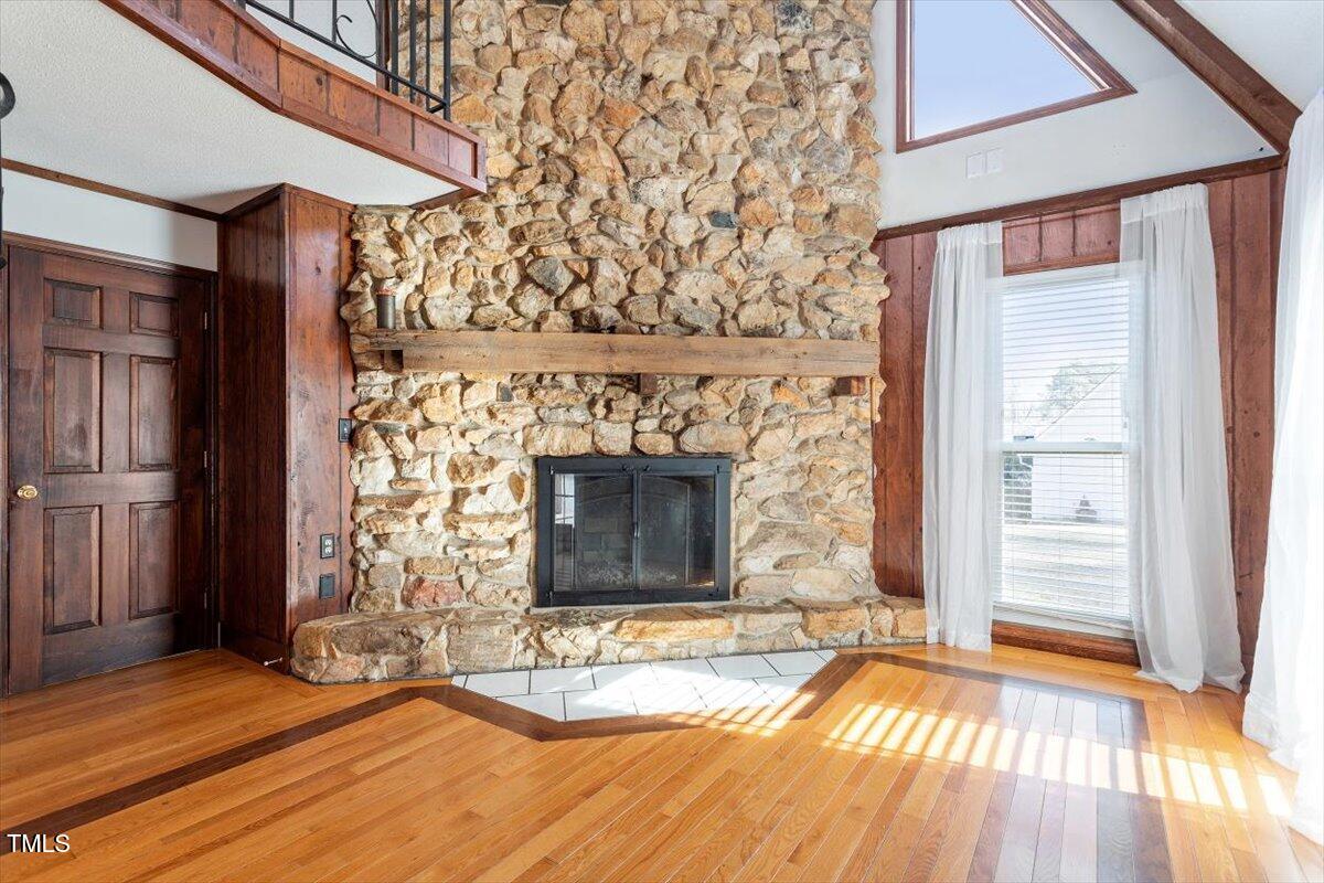 5707 Old Stage Road Raleigh, NC 27603 - Photo 28 of 50 an empty room with wooden floor fireplace and windows