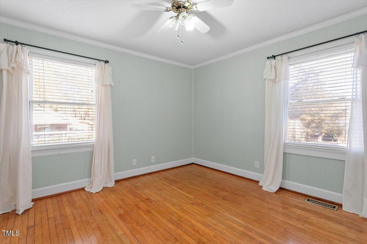 5707 Old Stage Road Raleigh, NC 27603 - Photo 32 of 50 an empty room with a window and a ceiling fan