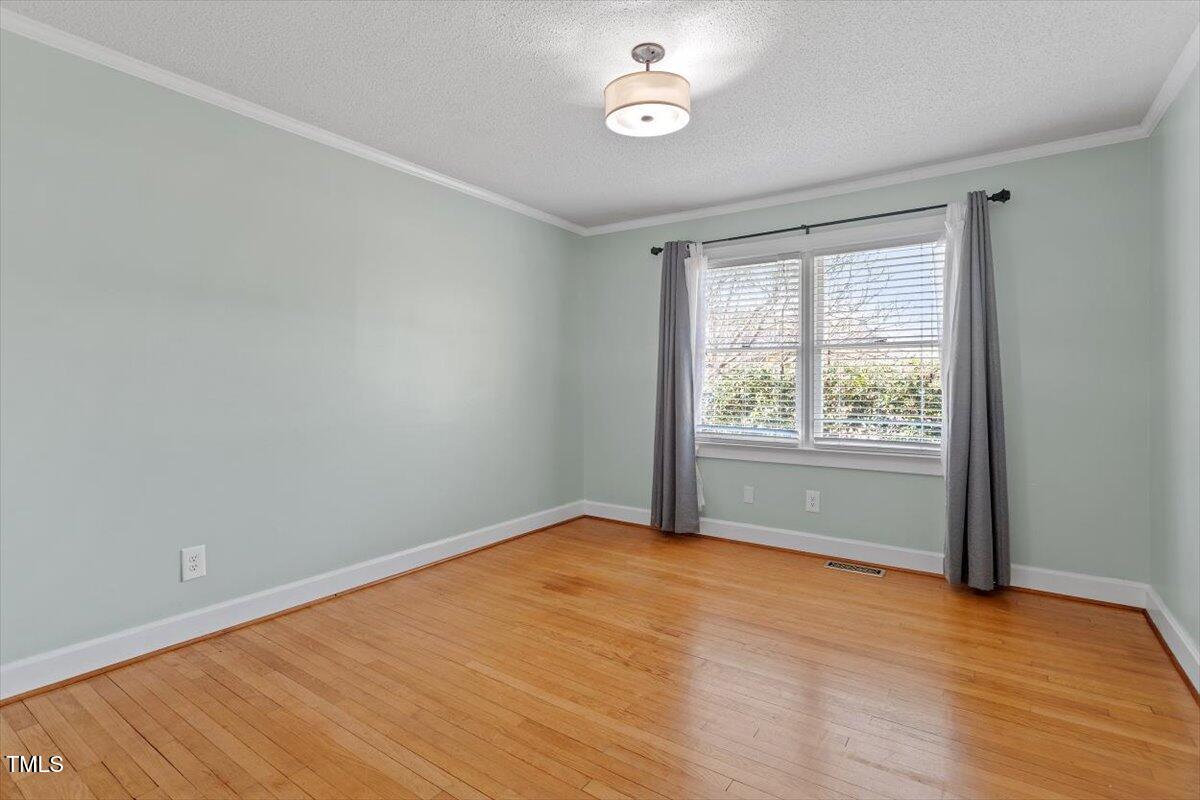 5707 Old Stage Road Raleigh, NC 27603 - Photo 33 of 50 an empty room with wooden floor and windows