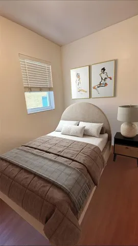 a bedroom with a large bed and a window