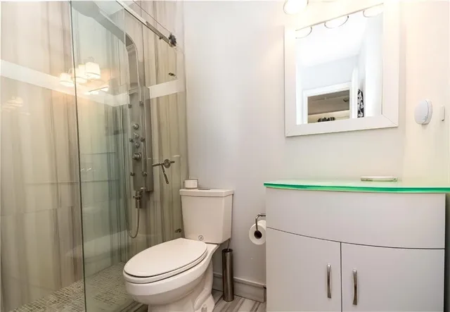 a bathroom with a toilet a sink and shower