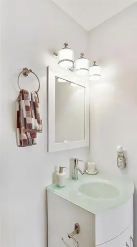 a bathroom with a sink vanity and mirror