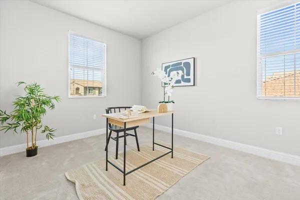 a view of a livingroom with furniture and a potted plant