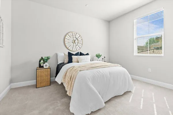 a bedroom with a bed and a window