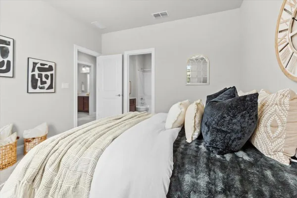 a bedroom with a large bed and a window