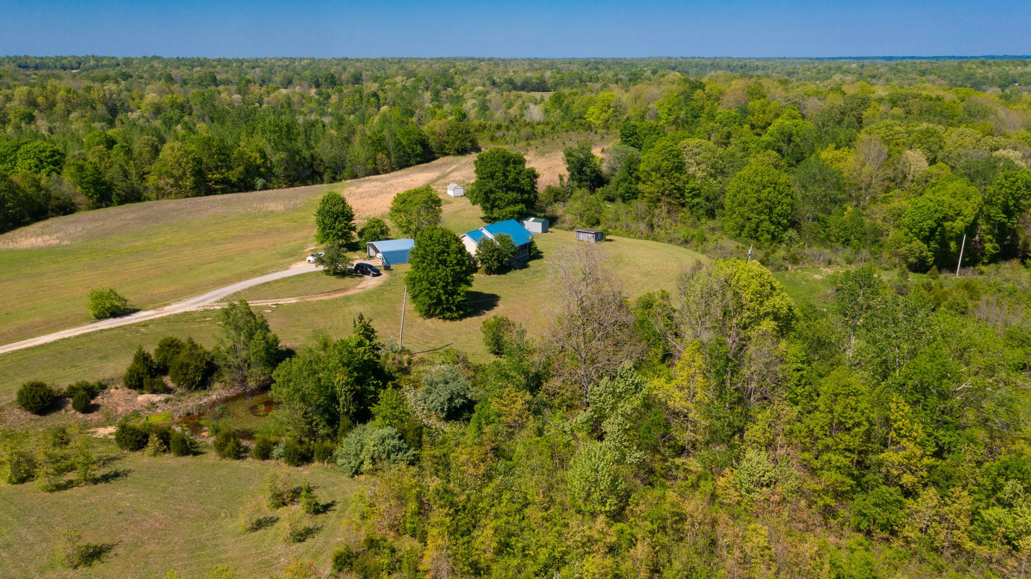 881 Coaling Road Charlotte, TN 37036 - Photo 2 of 29 a view of a lake with a mountain in the background