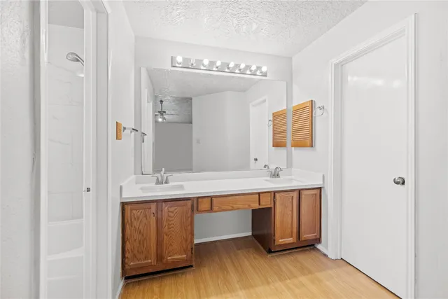 a bathroom with a double vanity sink and a mirror
