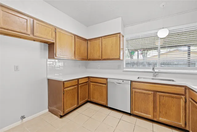 a kitchen with cabinets appliances a sink and a window