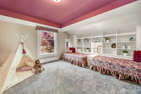 a bedroom with three beds and a window