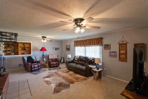a living room with furniture gym equipment and a flat screen tv
