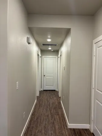 a view of hallway with wooden floor