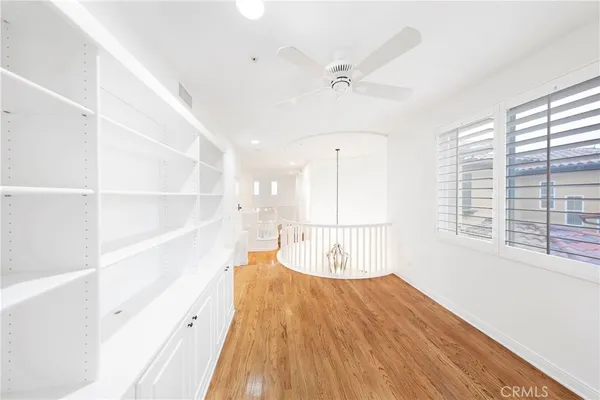 a view of a room with wooden floor and windows