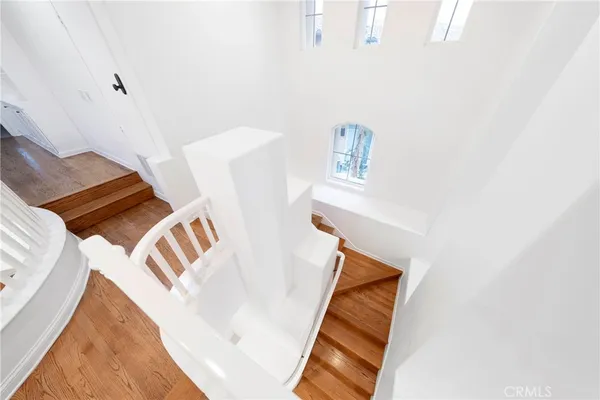 a living room with furniture and a white wall painting