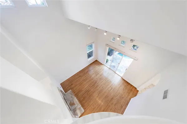 a view of a livingroom with wooden floor and a ceiling fan