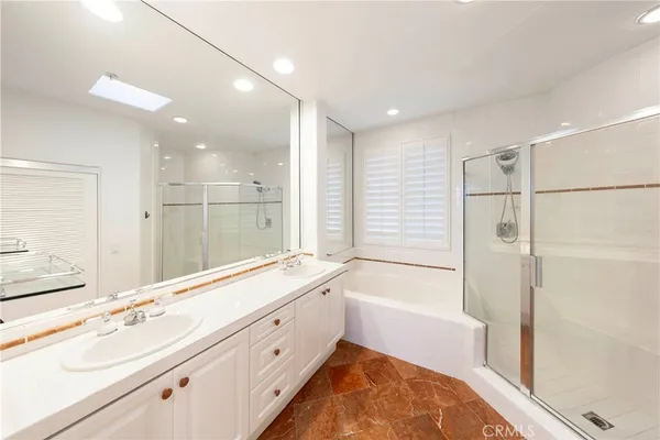 a view of a big room with wooden floor and windows