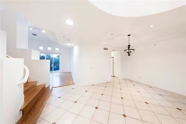a view of a kitchen with a sink and a wooden floor