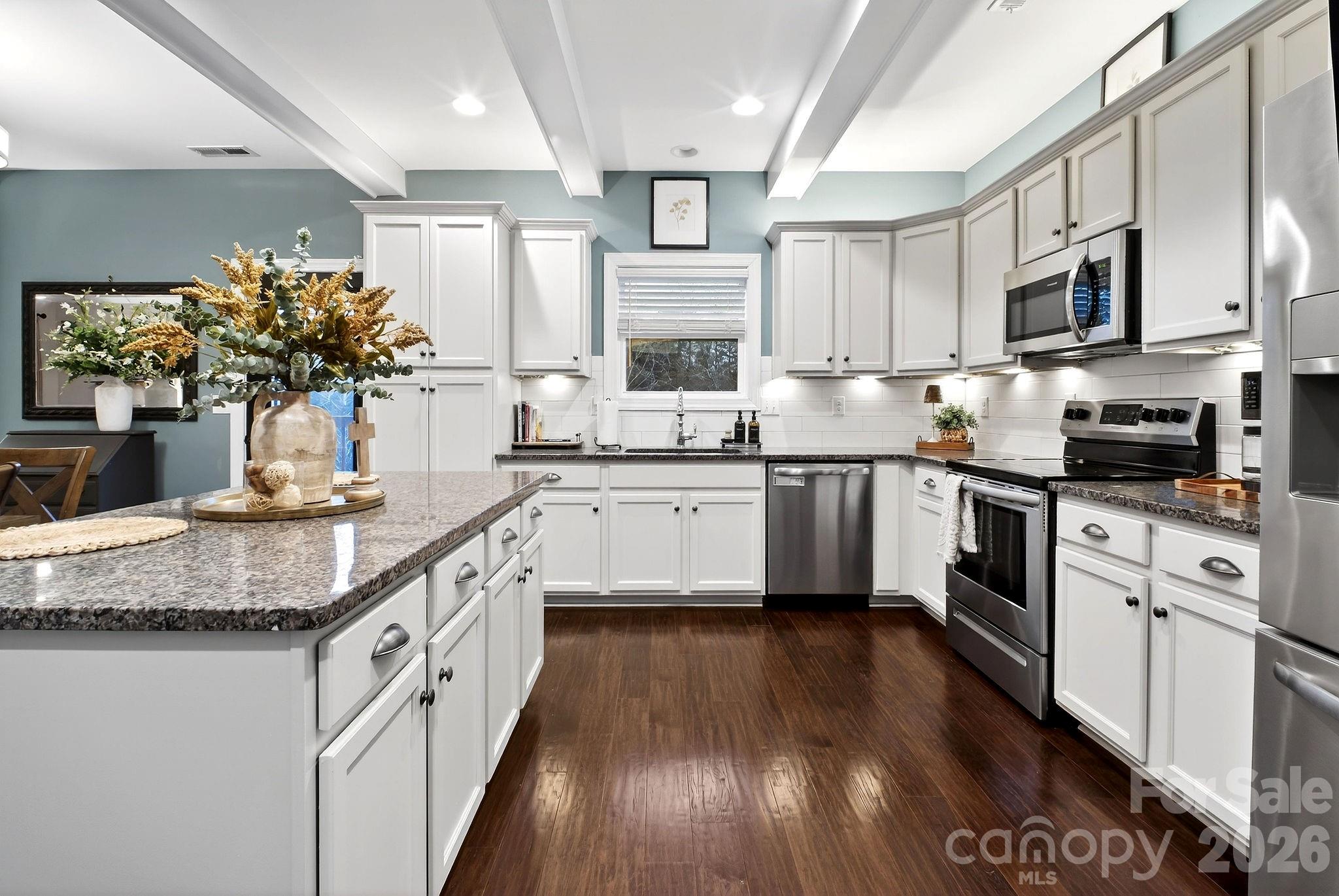 9092 Pitcairn Drive Fort Mill, SC 29708 - Photo 15 of 47 a kitchen with stainless steel appliances granite countertop a sink a stove top oven a counter space and cabinets