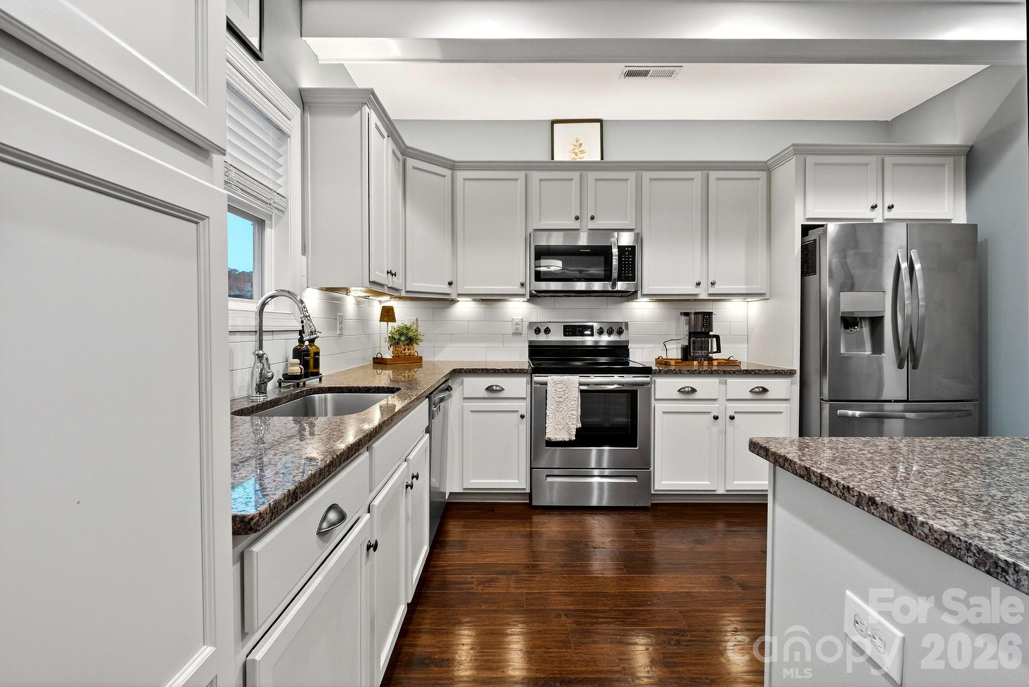 9092 Pitcairn Drive Fort Mill, SC 29708 - Photo 18 of 47 a kitchen with stainless steel appliances granite countertop a stove a sink and a refrigerator