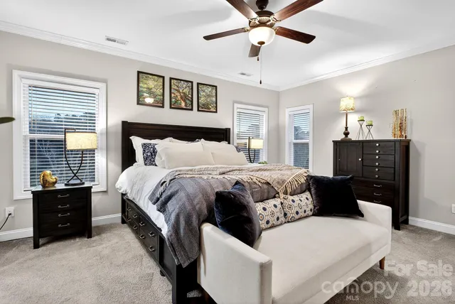 a bedroom with a bed and ceiling fan