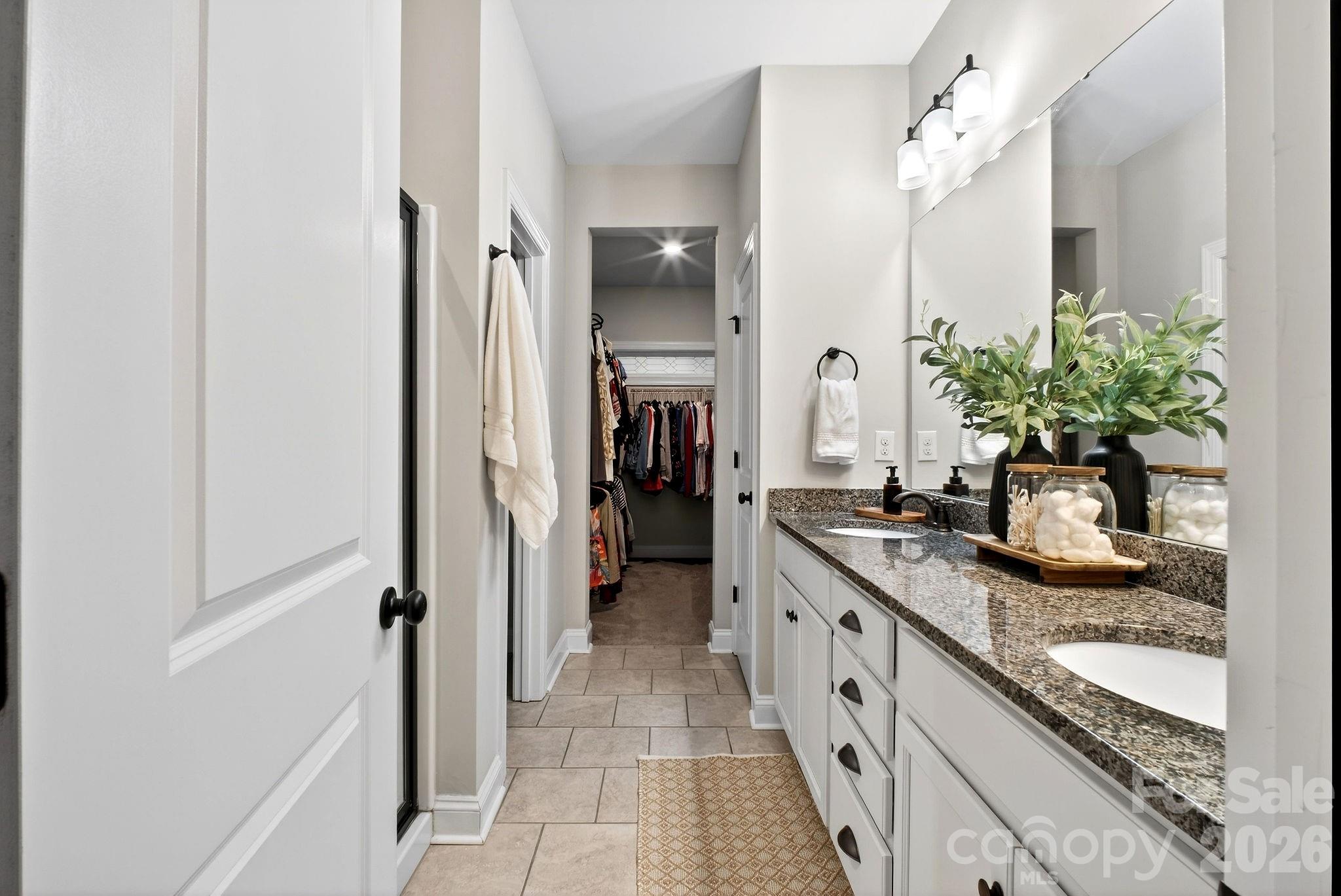 9092 Pitcairn Drive Fort Mill, SC 29708 - Photo 24 of 47 a spacious bathroom with a granite countertop sink and a mirror