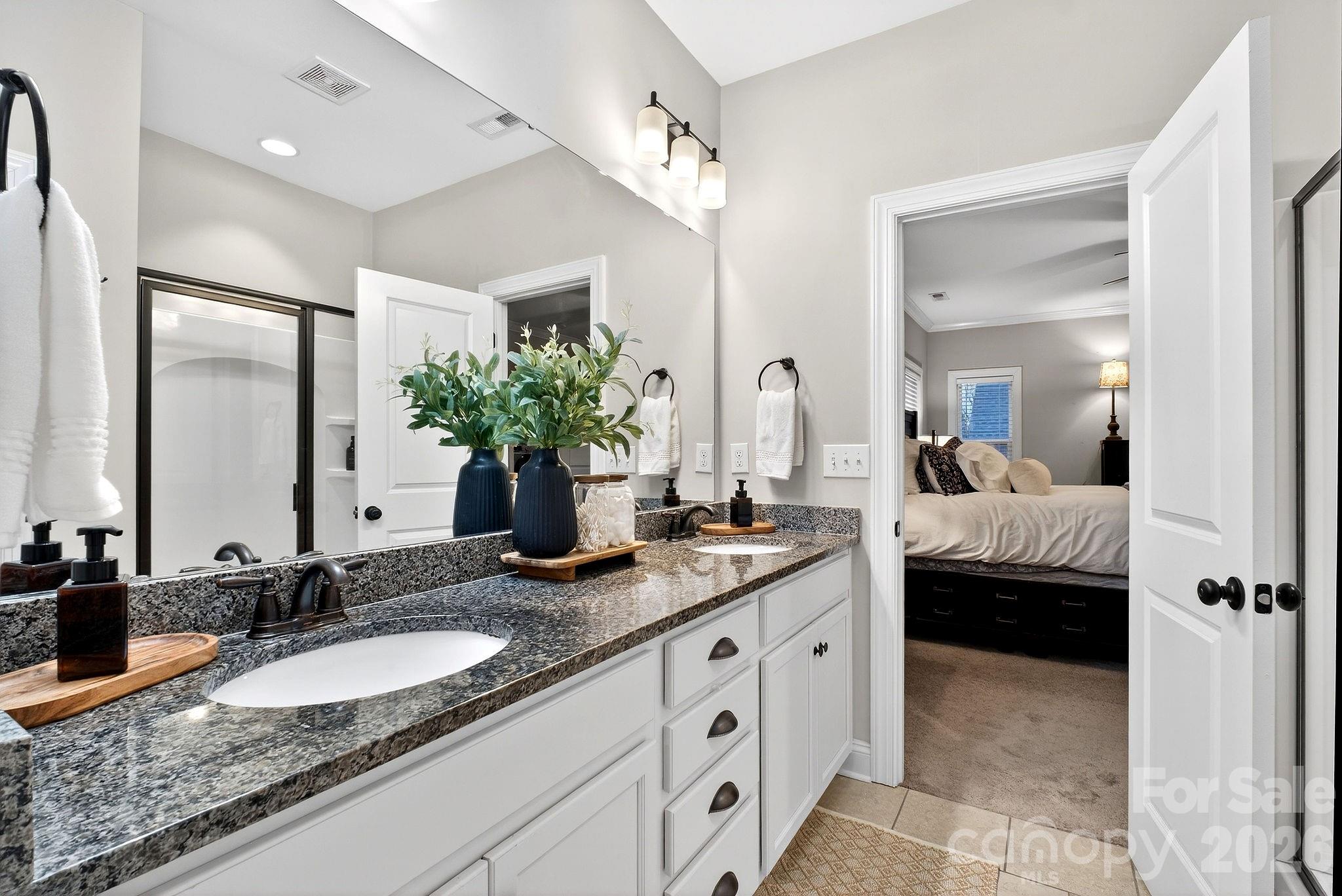 9092 Pitcairn Drive Fort Mill, SC 29708 - Photo 26 of 47 a en suite bathroom with double sink and a mirror