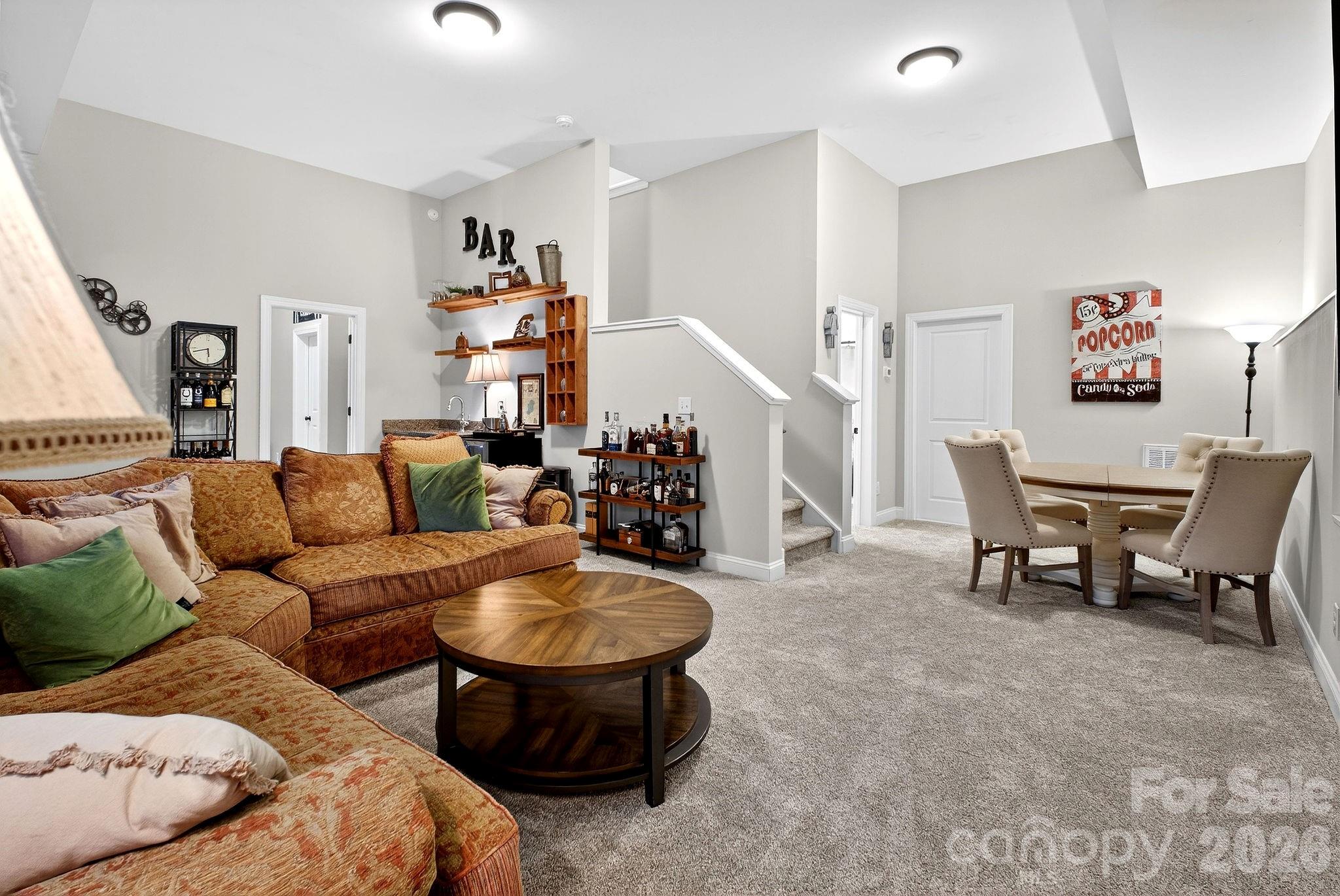 9092 Pitcairn Drive Fort Mill, SC 29708 - Photo 40 of 47 a living room with furniture and a chandelier