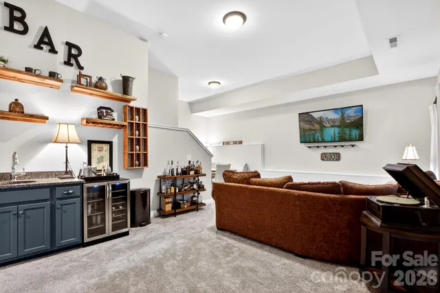 a living room with furniture a flat screen tv and a dresser