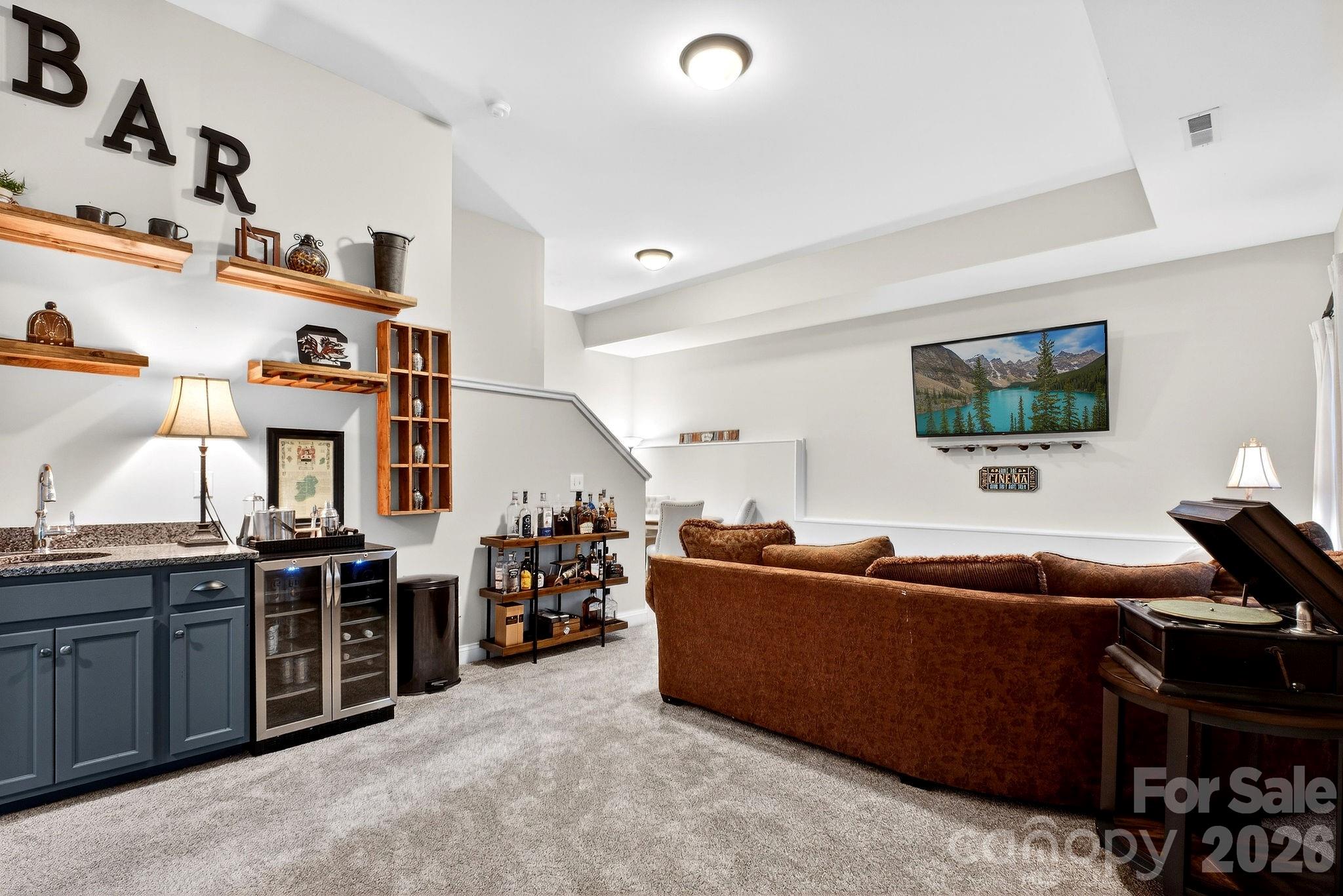 9092 Pitcairn Drive Fort Mill, SC 29708 - Photo 41 of 47 a living room with furniture a flat screen tv and a dresser