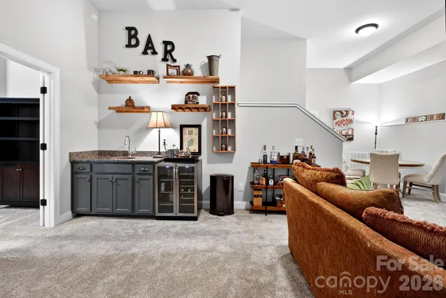 a living room with furniture and cabinets