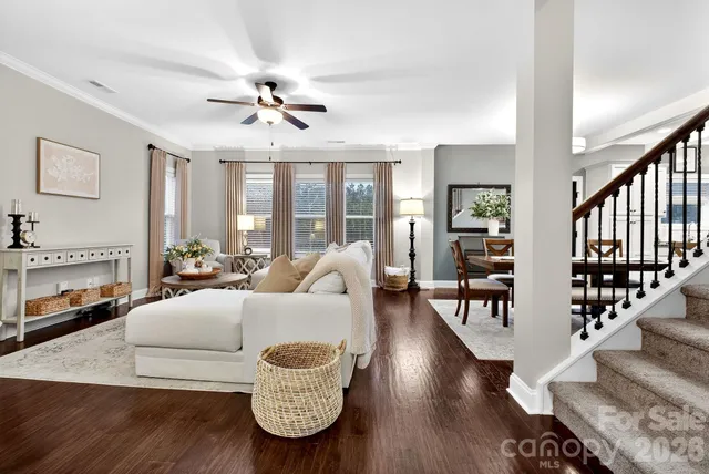 a living room with furniture fireplace and wooden floor