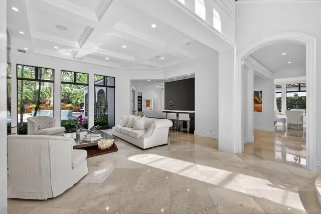 a dining room with furniture a chandelier and wooden floor
