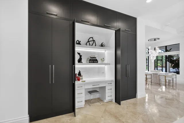 a living room with fireplace furniture and a large window