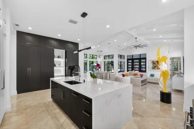 a view of a house with backyard sitting area and swimming pool