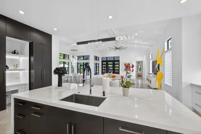 a view of a swimming pool with a table and chairs under an umbrella