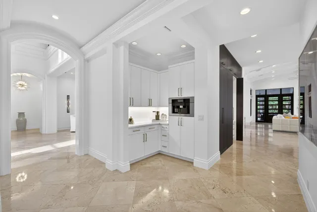 an aerial view of residential houses with outdoor space and trees all around