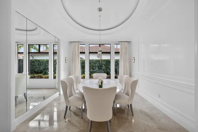 a view of a patio with table and chairs with wooden floor and fence