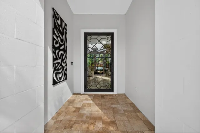 a view of a dining room with furniture a chandelier and wooden floor