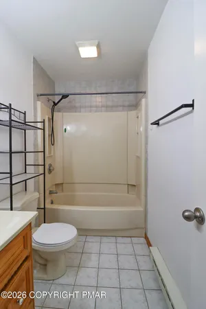 a bathroom with a toilet a sink and shower
