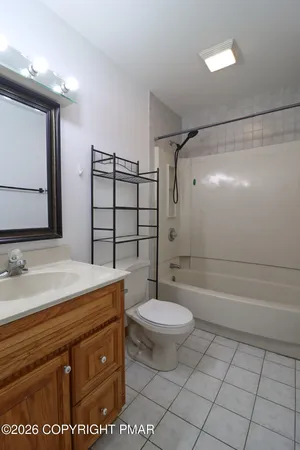 a bathroom with a sink a toilet a mirror and shower