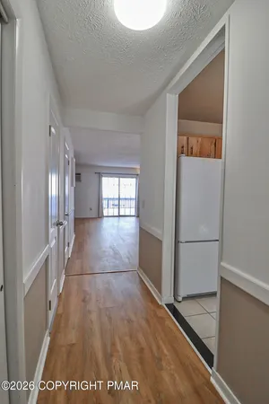 a view of a hallway with a white walls