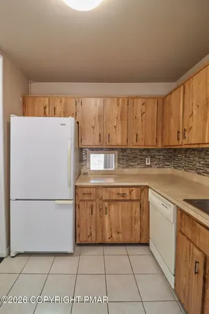 a kitchen with a refrigerator sink and cabinets