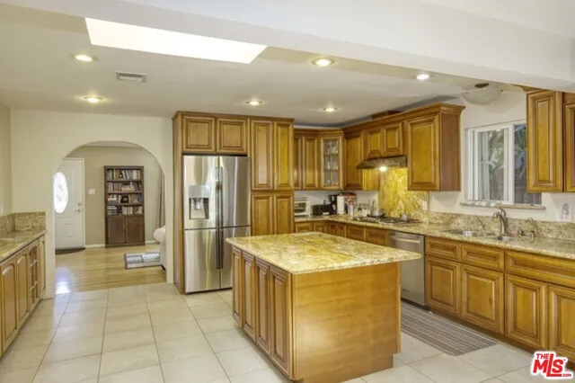 a kitchen with stainless steel appliances granite countertop a sink counter space cabinets and stainless steel appliances