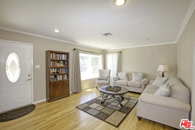 a living room with furniture rug and window